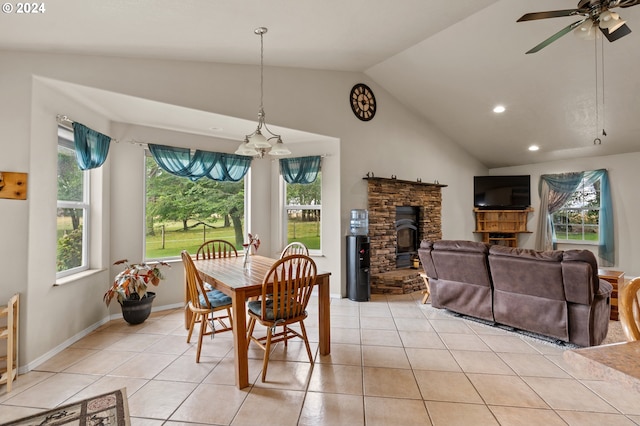 dining space with vaulted ceiling, light tile patterned floors, and a healthy amount of sunlight