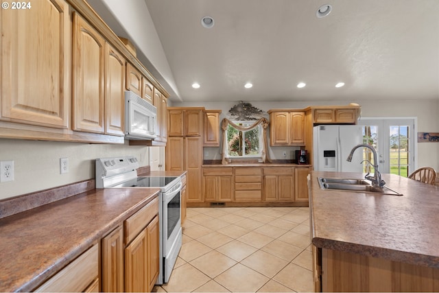 kitchen with white appliances, sink, light tile patterned floors, and french doors