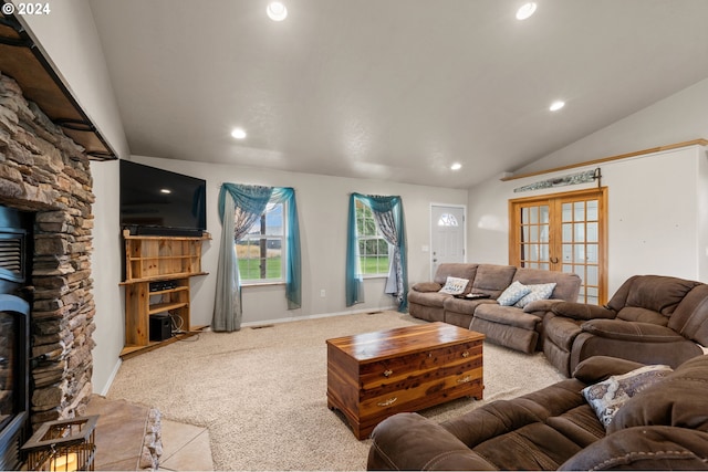 carpeted living room featuring french doors and vaulted ceiling