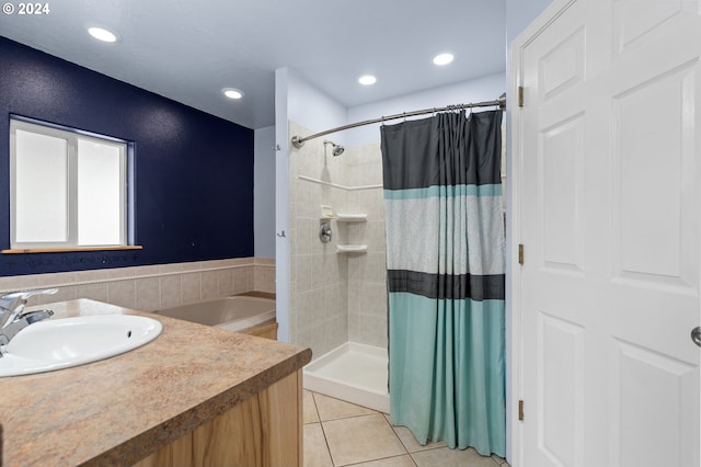 bathroom with tile patterned flooring, separate shower and tub, and sink