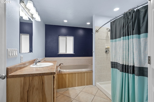 bathroom with independent shower and bath, vanity, and tile patterned flooring