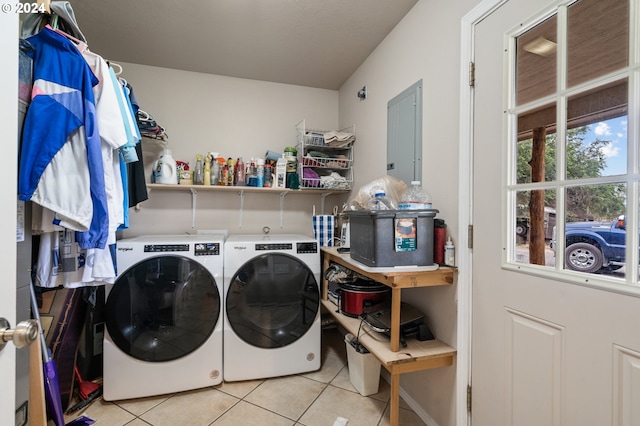 clothes washing area with washing machine and dryer and light tile patterned floors