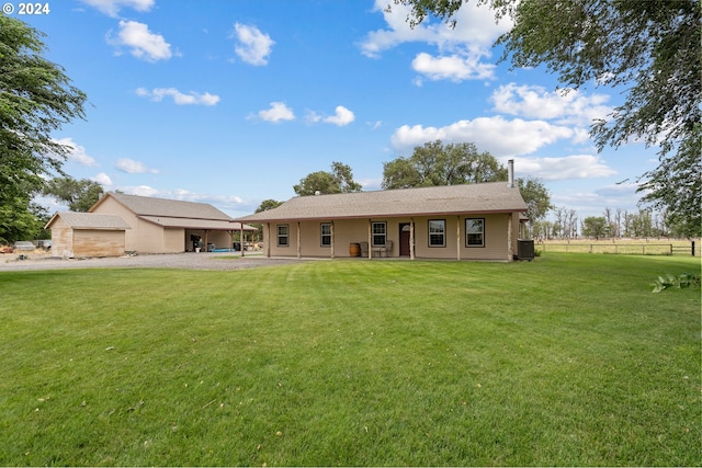 view of front of house with central AC and a front yard