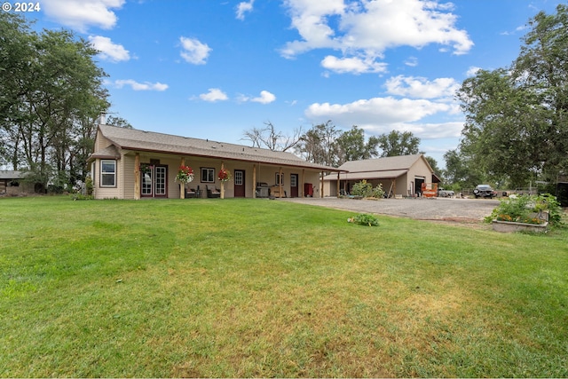 rear view of house with a yard