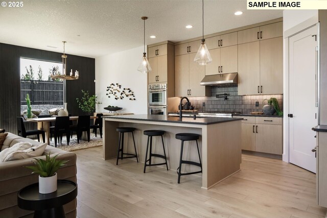 8156 N Hargrave St, Camas, WA 98607 - living room with baseboards, a fireplace, wood finished floors, and a healthy amount of sunlight
