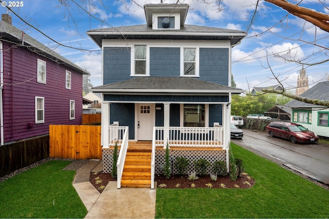 front facade featuring a front lawn and covered porch