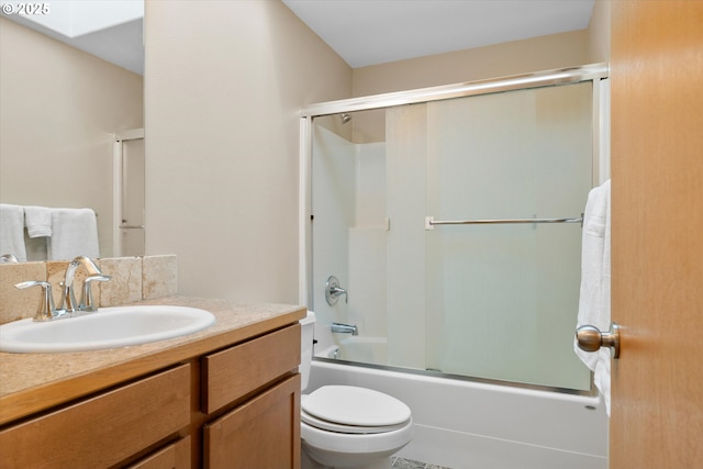 full bathroom featuring shower / bath combination with glass door, vanity, and toilet