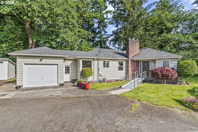 single story home featuring a garage and a front yard