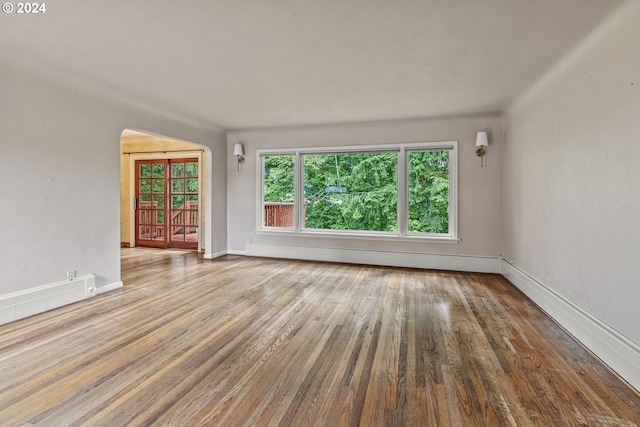 empty room featuring light hardwood / wood-style floors and baseboard heating