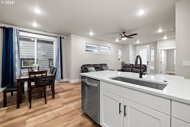 kitchen featuring dishwasher, sink, light wood-type flooring, white cabinets, and ceiling fan