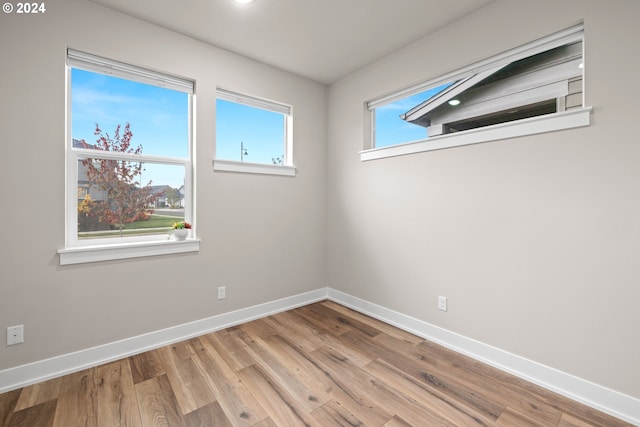 unfurnished room with light wood-type flooring