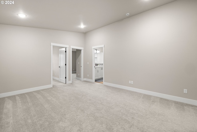 carpeted spare room featuring lofted ceiling