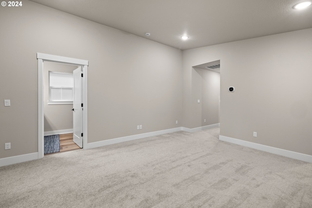 empty room featuring light colored carpet