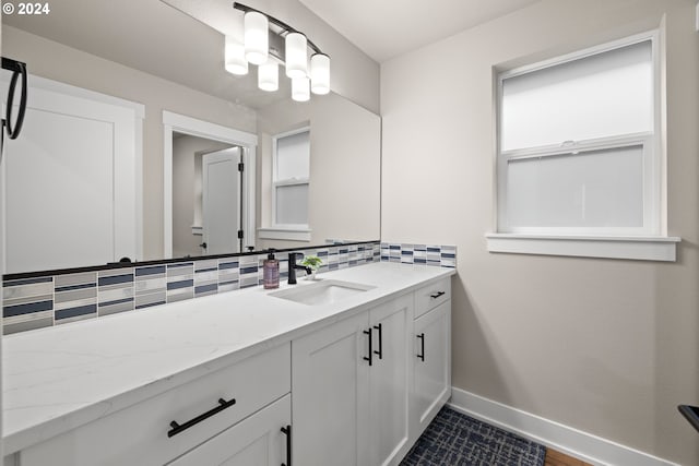 bathroom featuring vanity and decorative backsplash