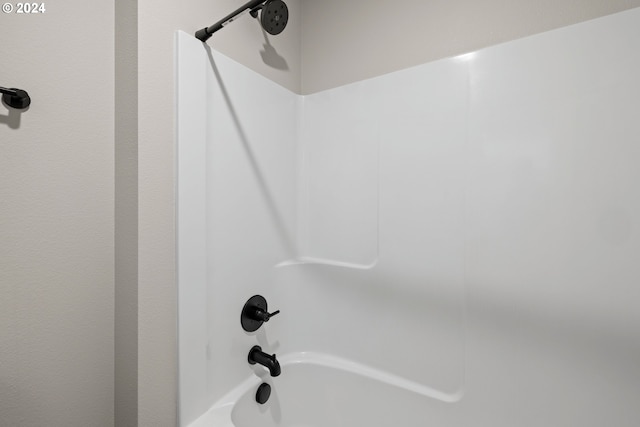 room details featuring shower / bathtub combination