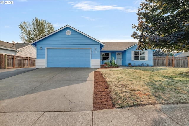 single story home with a front yard and a garage