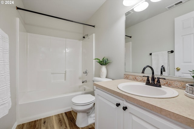 full bathroom with vanity, toilet, hardwood / wood-style flooring, and shower / bathtub combination with curtain