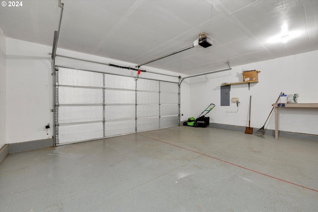 garage with a garage door opener and electric panel