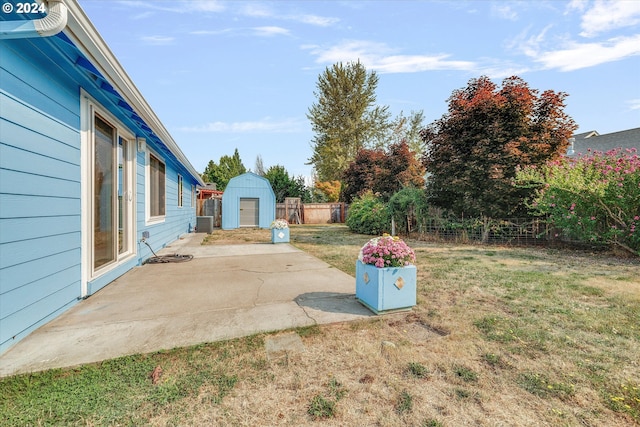 view of yard with a shed and a patio