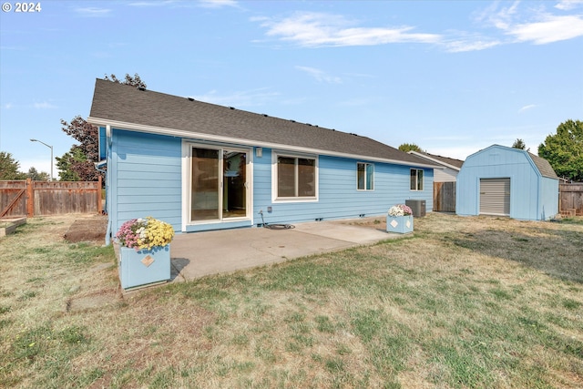 back of property with a patio, a storage shed, central AC unit, and a lawn