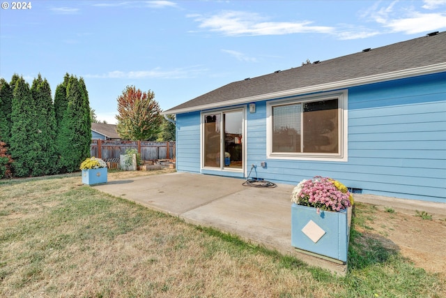 back of house featuring a yard and a patio