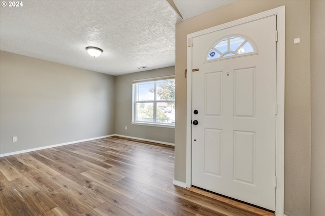 foyer featuring hardwood / wood-style floors and a textured ceiling