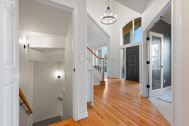 entryway featuring light hardwood / wood-style flooring and a notable chandelier