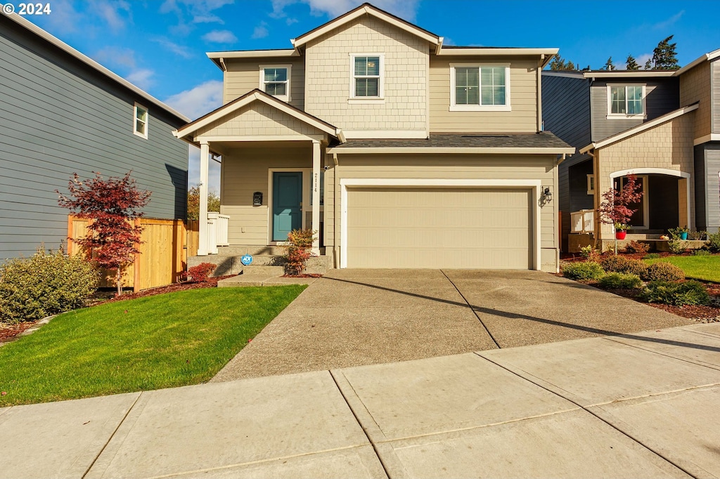 craftsman-style house featuring a front yard and a garage