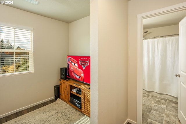 bathroom featuring hardwood / wood-style floors and walk in shower