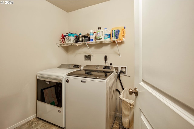 laundry area with washer and dryer and light hardwood / wood-style floors