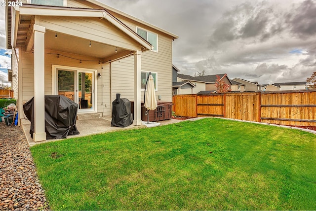 back of property with a patio area and a yard