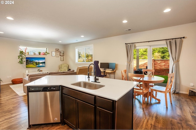 kitchen with sink, dishwasher, an island with sink, and dark hardwood / wood-style flooring