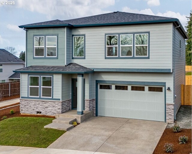 view of front of property with a front yard and a garage