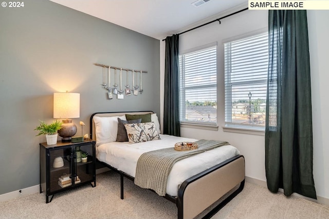 bedroom with light colored carpet