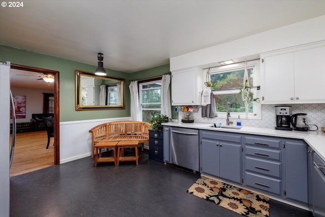 kitchen with ceiling fan, white cabinets, sink, backsplash, and dishwasher