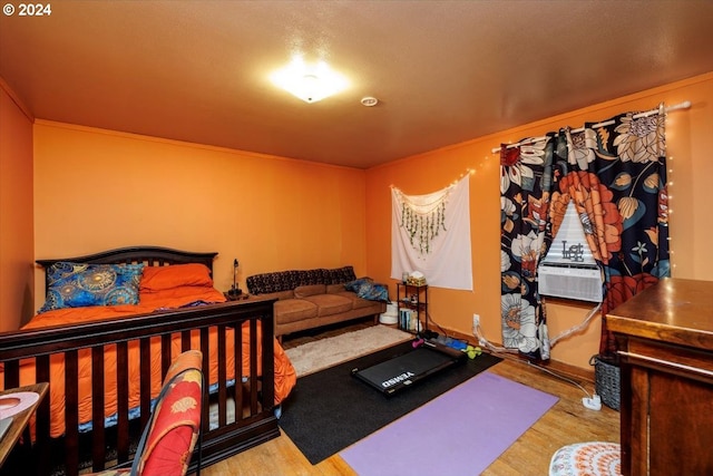 bedroom featuring cooling unit and light hardwood / wood-style floors