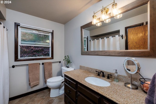 bathroom featuring tile patterned floors, vanity, and toilet