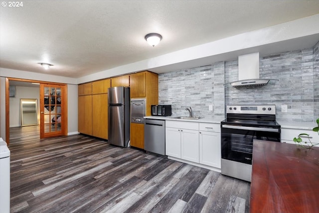 kitchen featuring wall chimney exhaust hood, backsplash, white cabinetry, stainless steel appliances, and dark hardwood / wood-style flooring