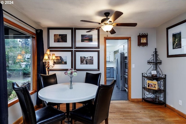 dining room with light hardwood / wood-style flooring and ceiling fan