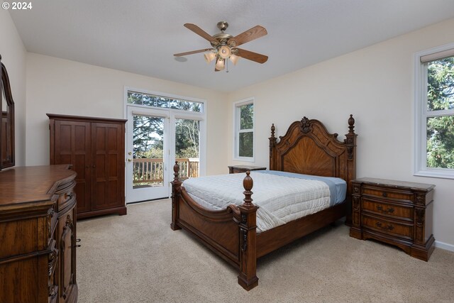 bedroom with access to exterior, ceiling fan, and light colored carpet