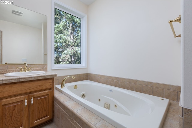 bathroom with tiled bath and vanity