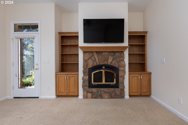 unfurnished living room featuring a fireplace and light carpet