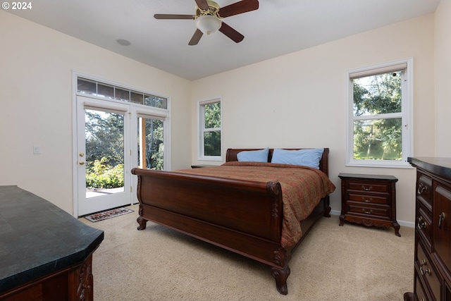 carpeted bedroom featuring ceiling fan, access to exterior, and multiple windows