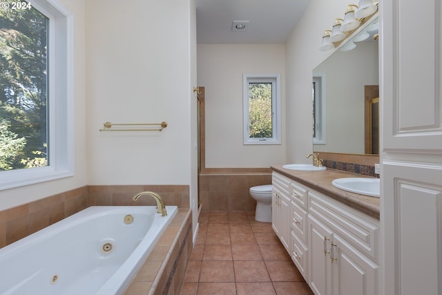 full bathroom with tile patterned flooring, vanity, shower with separate bathtub, and toilet