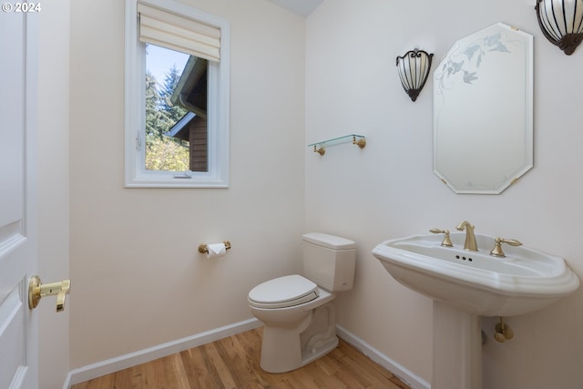 bathroom featuring hardwood / wood-style floors, toilet, and sink