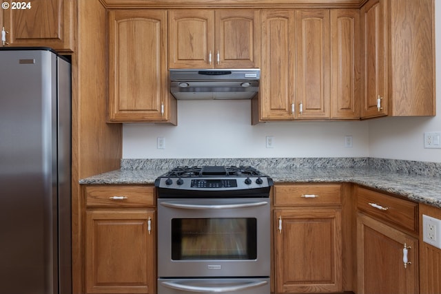 6605 Pacific Overlook Dr, Neskowin, OR 97149 - kitchen with stainless steel appliances, under cabinet range hood, and brown cabinetry