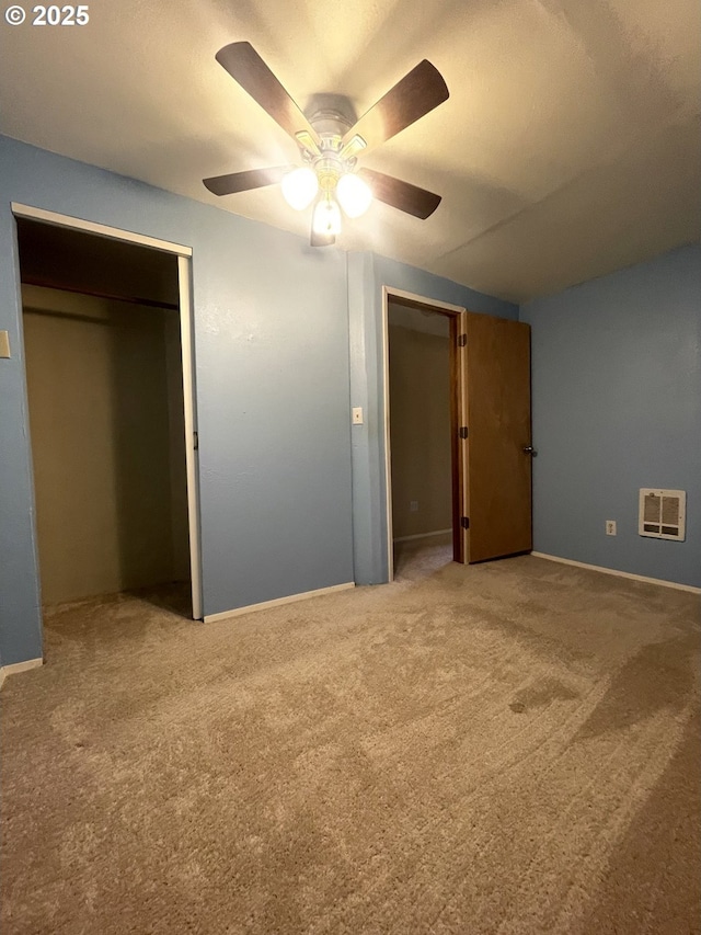 unfurnished bedroom with ceiling fan and carpet flooring