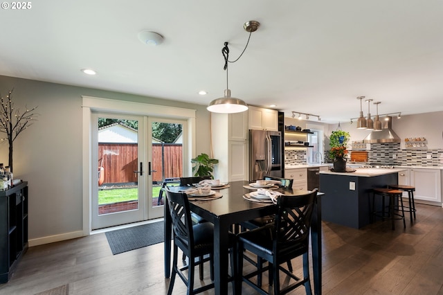 dining space with recessed lighting, dark wood-style floors, baseboards, and french doors