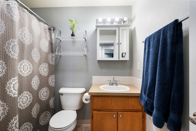 bathroom with decorative backsplash, a shower with shower curtain, toilet, and vanity