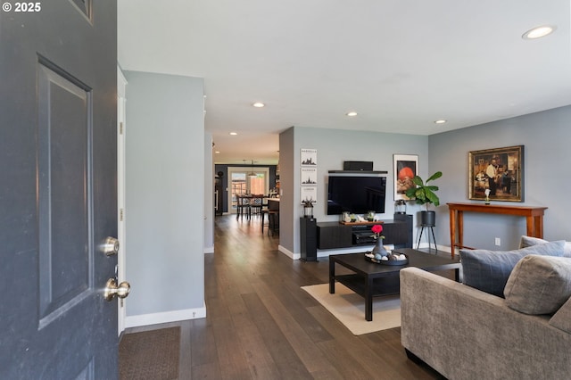 living area with recessed lighting, baseboards, and dark wood-style flooring